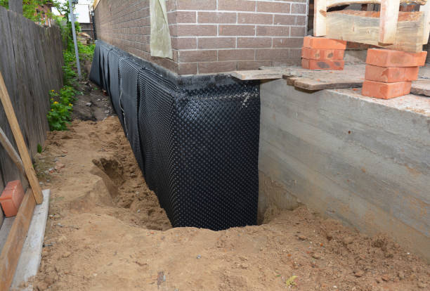 Happy homeowners after waterproofing job in Keshena